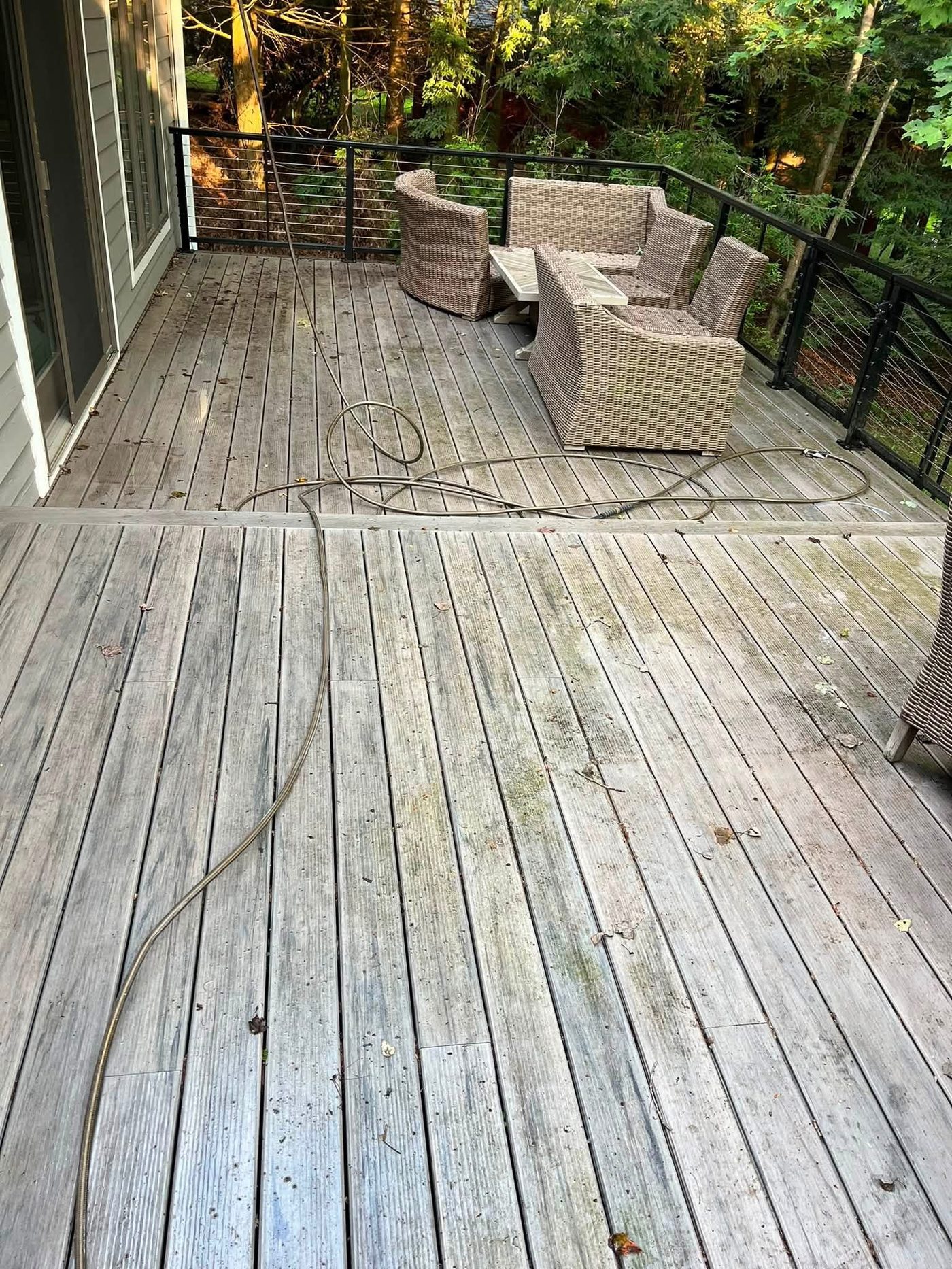 Wooden deck with dirt and algae staining before cleaning